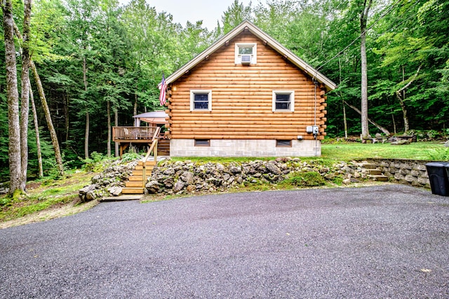 134 Valhalla Ln, Norway, ME 04268 - view of home's exterior with stairway, log siding, a deck, and a view of trees