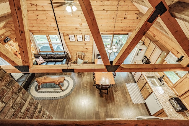 134 Valhalla Ln, Norway, ME 04268 - living area featuring wooden walls, wood finished floors, a ceiling fan, and a chandelier
