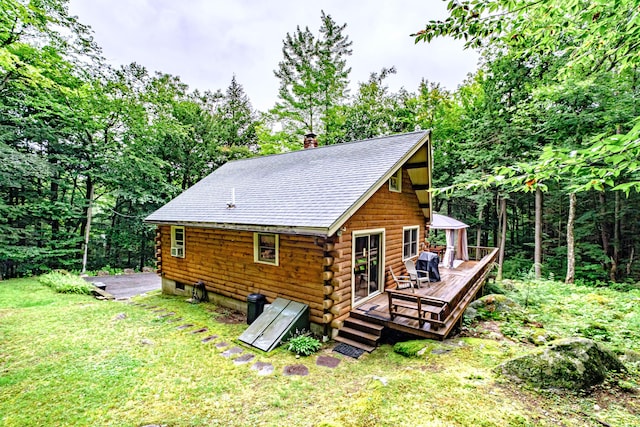 134 Valhalla Ln, Norway, ME 04268 - rear view of house featuring a wooden deck, log exterior, a shingled roof, a yard, and a chimney