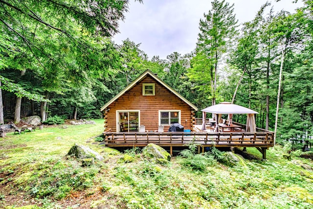 134 Valhalla Ln, Norway, ME 04268 - back of house featuring log siding, a gazebo, a wooden deck, and a forest view