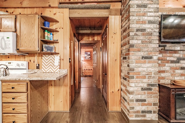 134 Valhalla Ln, Norway, ME 04268 - hall featuring wooden walls, dark wood-style flooring, and brick wall