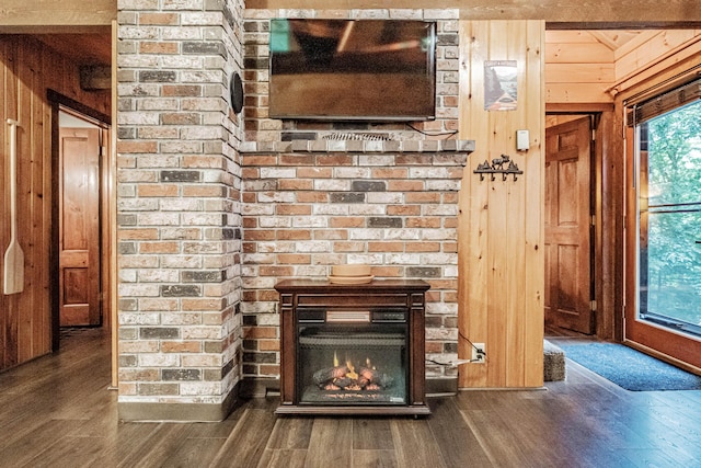 134 Valhalla Ln, Norway, ME 04268 - detailed view of wood walls, wood finished floors, and a brick fireplace