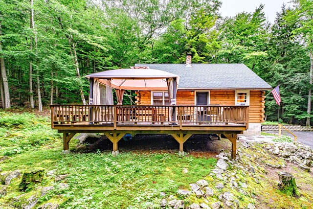 134 Valhalla Ln, Norway, ME 04268 - view of front facade with a gazebo, a wooden deck, log siding, and a shingled roof