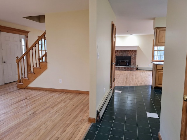 20 Brandywine Cir, Auburn, ME 04210 - hall featuring a baseboard heating unit, baseboard heating, dark wood-style flooring, baseboards, and stairs
