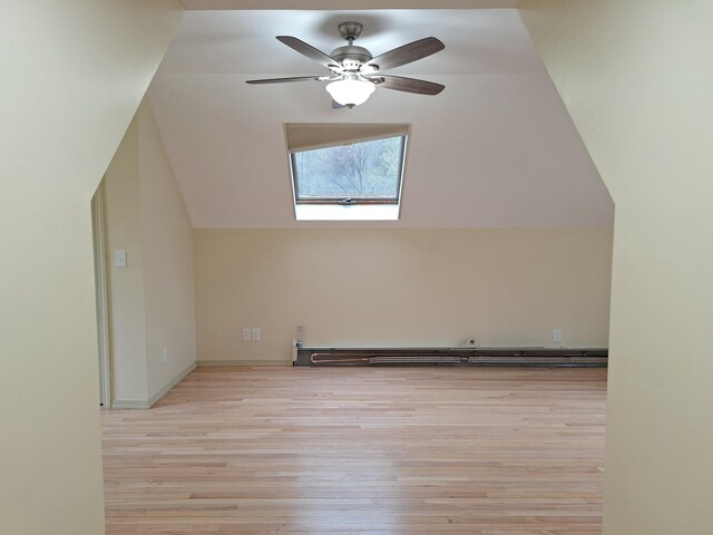 20 Brandywine Cir, Auburn, ME 04210 - additional living space with vaulted ceiling, light wood-style flooring, a skylight, ceiling fan, and a baseboard heating unit