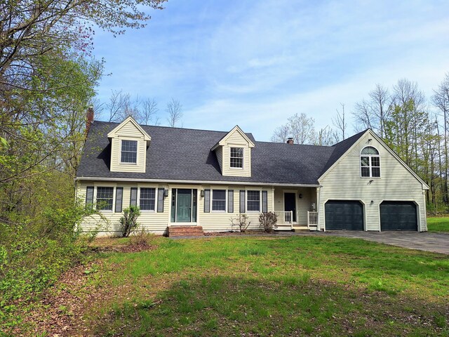 20 Brandywine Cir, Auburn, ME 04210 - view of front of home featuring a chimney, asphalt driveway, entry steps, a front yard, and a garage
