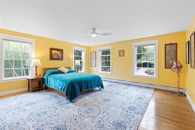 22 Lindas Way, Manchester, ME 04351 - bedroom with baseboards, light wood-type flooring, a baseboard heating unit, and a ceiling fan