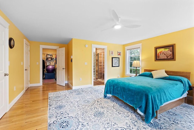22 Lindas Way, Manchester, ME 04351 - bedroom featuring light wood-style flooring, baseboards, a walk in closet, and ensuite bathroom
