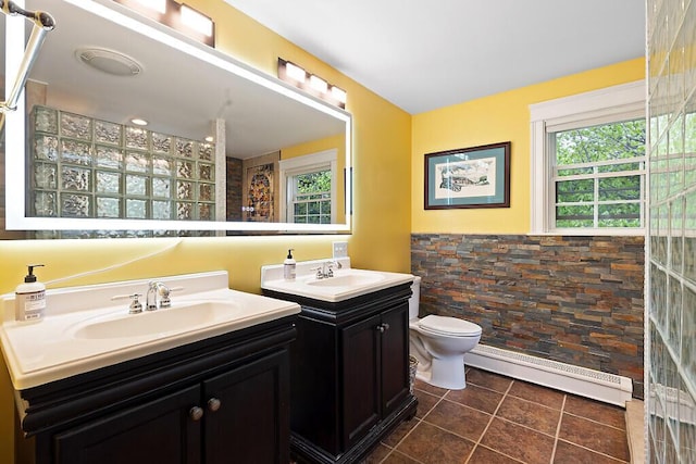 22 Lindas Way, Manchester, ME 04351 - full bath with a baseboard heating unit, two vanities, toilet, and tile patterned flooring