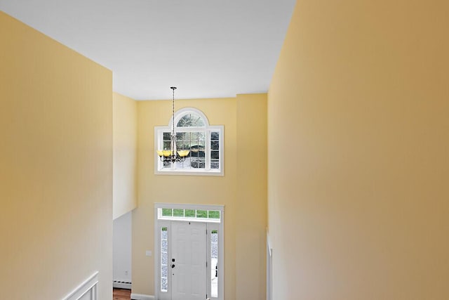 22 Lindas Way, Manchester, ME 04351 - foyer entrance featuring plenty of natural light, a chandelier, a towering ceiling, a baseboard heating unit, and baseboards