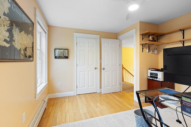 22 Lindas Way, Manchester, ME 04351 - office space with wood finished floors, baseboards, a baseboard heating unit, and healthy amount of natural light