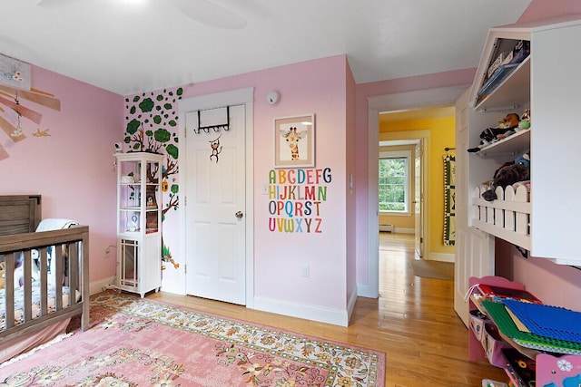 22 Lindas Way, Manchester, ME 04351 - bedroom with light wood-type flooring, baseboard heating, and baseboards