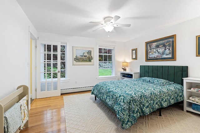 22 Lindas Way, Manchester, ME 04351 - bedroom featuring baseboard heating, light wood-style flooring, and a ceiling fan