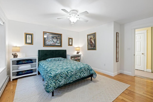 22 Lindas Way, Manchester, ME 04351 - bedroom featuring baseboard heating, light wood-style flooring, baseboards, and ceiling fan