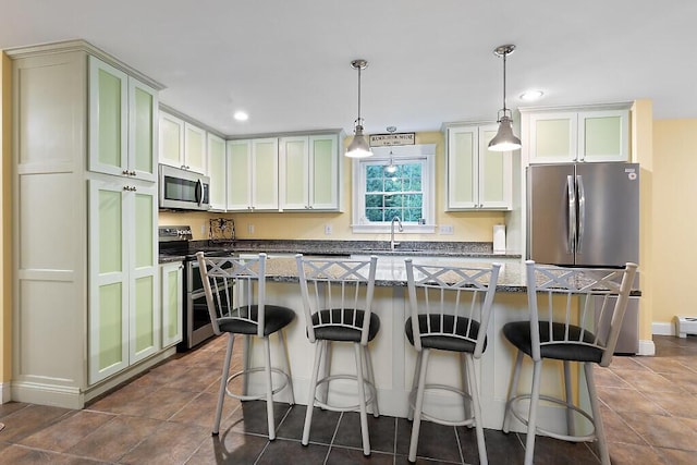 22 Lindas Way, Manchester, ME 04351 - kitchen featuring appliances with stainless steel finishes, dark stone counters, a sink, a kitchen bar, and recessed lighting
