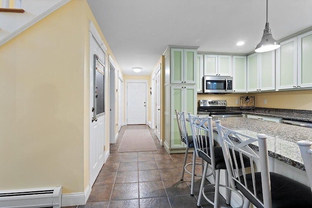 22 Lindas Way, Manchester, ME 04351 - kitchen featuring stainless steel appliances, a baseboard radiator, a breakfast bar, dark stone countertops, and baseboards