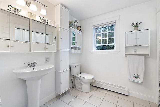 22 Lindas Way, Manchester, ME 04351 - full bath with baseboard heating, baseboards, toilet, tile patterned floors, and a sink