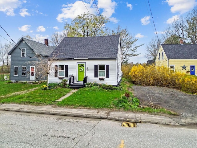 66 Beechwood St, Thomaston, ME 04861 - view of front of property featuring a chimney, roof with shingles, and a front lawn