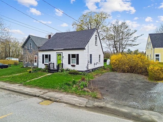 66 Beechwood St, Thomaston, ME 04861 - view of front facade with roof with shingles and a front yard