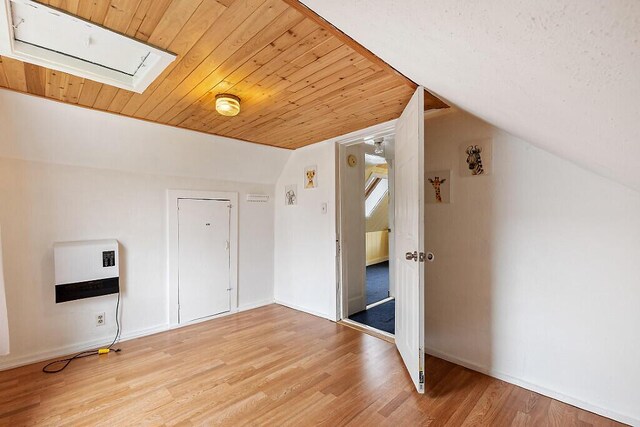 66 Beechwood St, Thomaston, ME 04861 - additional living space with light wood-style floors, wood ceiling, heating unit, and vaulted ceiling