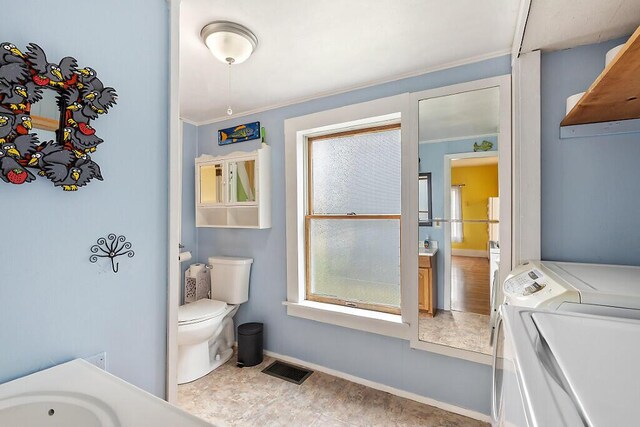 66 Beechwood St, Thomaston, ME 04861 - bathroom featuring independent washer and dryer, toilet, baseboards, and crown molding