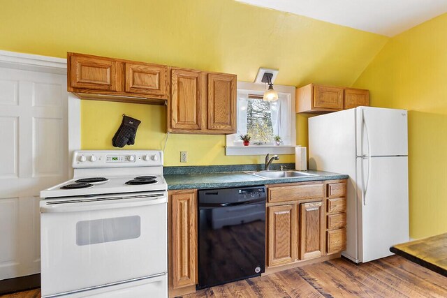 66 Beechwood St, Thomaston, ME 04861 - kitchen featuring white appliances, a sink, wood finished floors, dark countertops, and vaulted ceiling