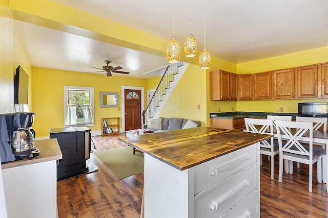 66 Beechwood St, Thomaston, ME 04861 - kitchen with open floor plan, butcher block counters, dark wood finished floors, brown cabinetry, and a ceiling fan