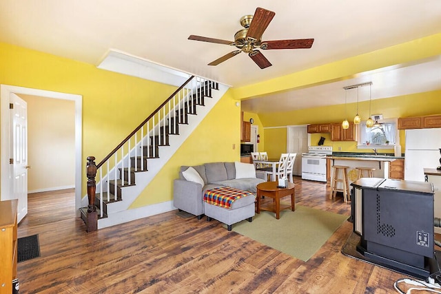 66 Beechwood St, Thomaston, ME 04861 - living room with stairway, dark wood-style floors, a ceiling fan, and baseboards