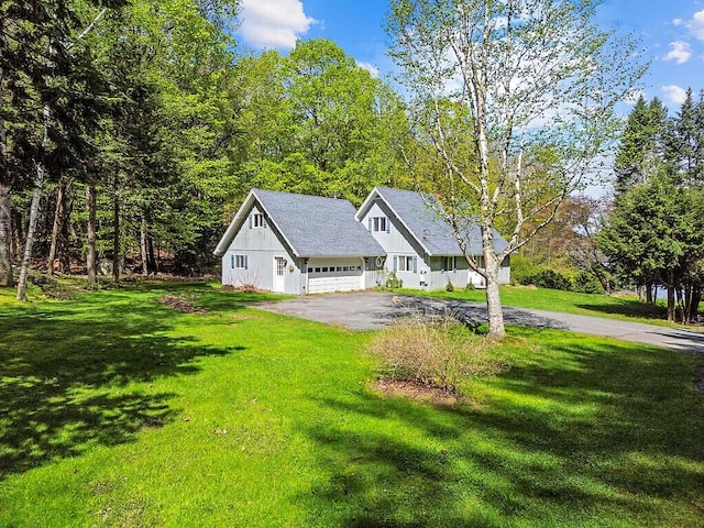 66 Brickett Point Ests, Oakland, ME 04963 - view of front of home with driveway, a front yard, an attached garage, and a shingled roof