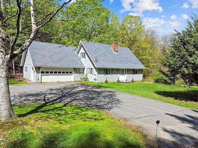 66 Brickett Point Ests, Oakland, ME 04963 - view of front of property featuring driveway, a chimney, a garage, a front lawn, and roof with shingles