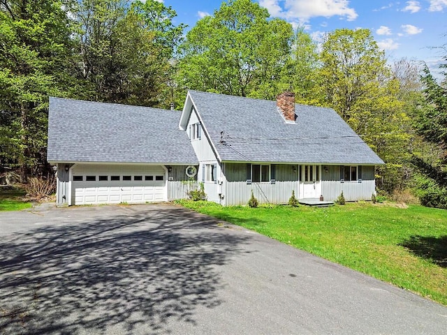 66 Brickett Point Ests, Oakland, ME 04963 - view of front facade featuring asphalt driveway, a chimney, a front lawn, a garage, and a shingled roof