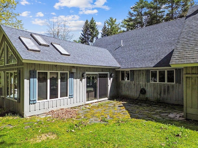 66 Brickett Point Ests, Oakland, ME 04963 - back of property featuring board and batten siding, a shingled roof, and a lawn