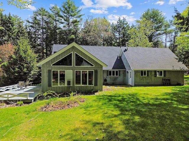 66 Brickett Point Ests, Oakland, ME 04963 - rear view of property with a wooden deck, board and batten siding, a lawn, and roof with shingles