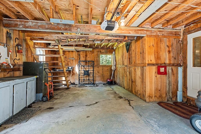 66 Brickett Point Ests, Oakland, ME 04963 - interior space featuring concrete flooring, wooden walls, and a garage