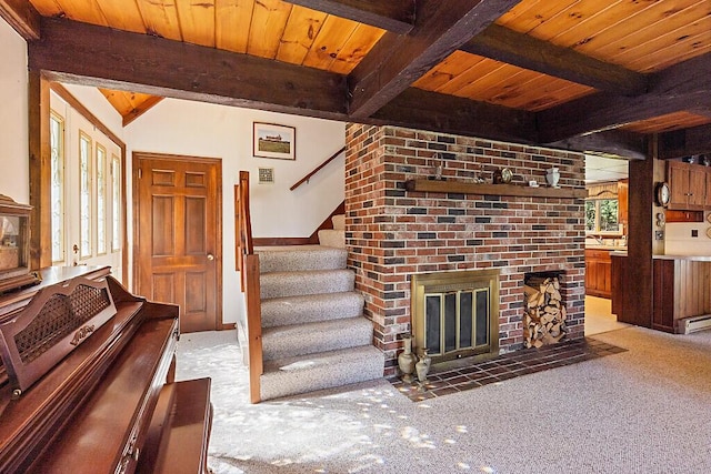 66 Brickett Point Ests, Oakland, ME 04963 - unfurnished living room featuring wooden ceiling, stairs, beamed ceiling, carpet flooring, and a brick fireplace