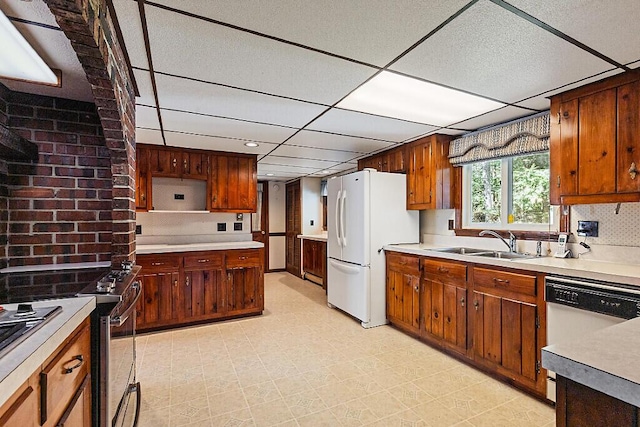 66 Brickett Point Ests, Oakland, ME 04963 - kitchen featuring a sink, white appliances, a drop ceiling, light countertops, and light floors