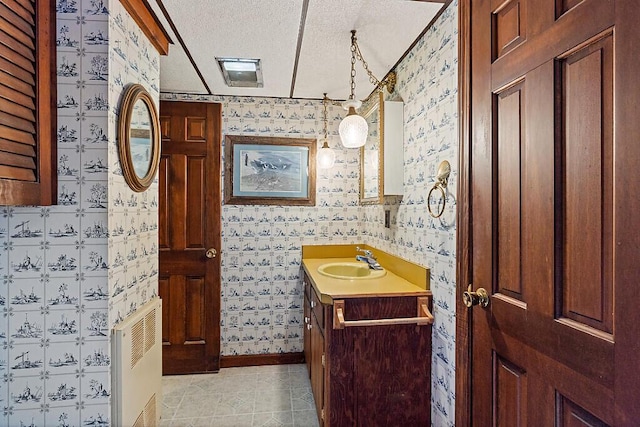 66 Brickett Point Ests, Oakland, ME 04963 - bathroom featuring wallpapered walls, vanity, a textured ceiling, and tile patterned flooring