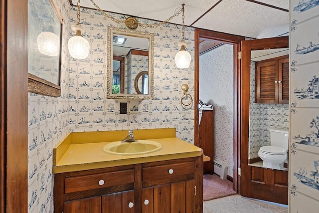 66 Brickett Point Ests, Oakland, ME 04963 - bathroom featuring baseboard heating, toilet, wallpapered walls, and vanity