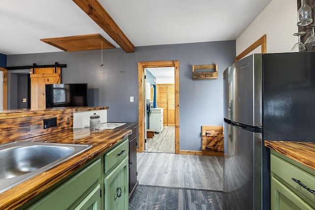 194 Birch Ln, Unity, ME 04988 - kitchen with green cabinets, freestanding refrigerator, butcher block countertops, wood finished floors, and beam ceiling