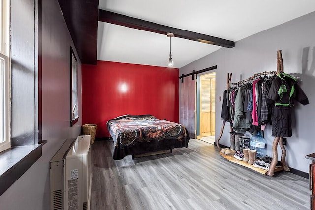 194 Birch Ln, Unity, ME 04988 - bedroom with wood finished floors, beamed ceiling, and a barn door