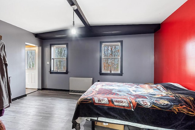 194 Birch Ln, Unity, ME 04988 - bedroom featuring wood finished floors, beam ceiling, baseboards, and radiator heating unit