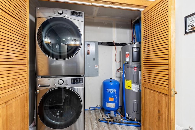 194 Birch Ln, Unity, ME 04988 - clothes washing area featuring stacked washer and clothes dryer, water heater, wood finished floors, and electric panel