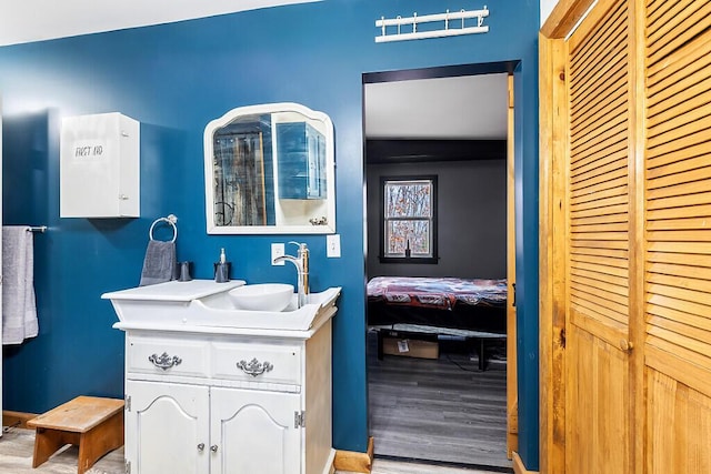 194 Birch Ln, Unity, ME 04988 - bathroom with wood finished floors, vanity, and baseboards