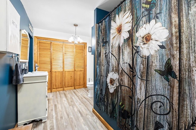 194 Birch Ln, Unity, ME 04988 - bathroom featuring wood finished floors, toilet, a chandelier, and vanity