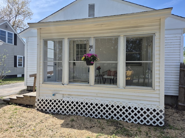 rear view of property with a sunroom