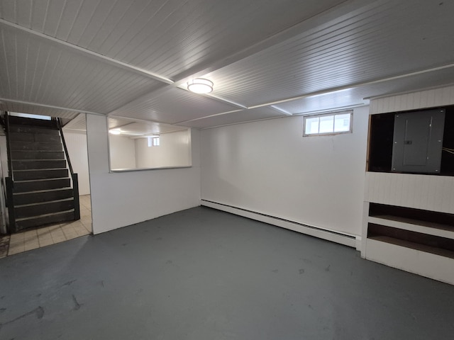 below grade area featuring a baseboard radiator, electric panel, and stairway