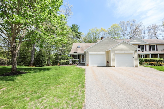 28 Winchester Ct Unit 36, Kennebunk, ME 04043 - view of front of property featuring an attached garage, a front yard, asphalt driveway, and a chimney
