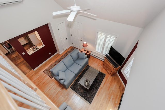 28 Winchester Ct Unit 36, Kennebunk, ME 04043 - living room featuring a baseboard radiator, wood finished floors, ceiling fan, and lofted ceiling