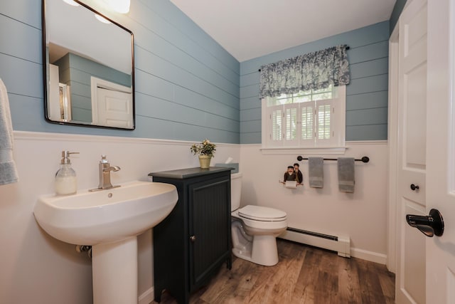 28 Winchester Ct Unit 36, Kennebunk, ME 04043 - bathroom featuring a baseboard radiator, wood walls, toilet, and wood finished floors