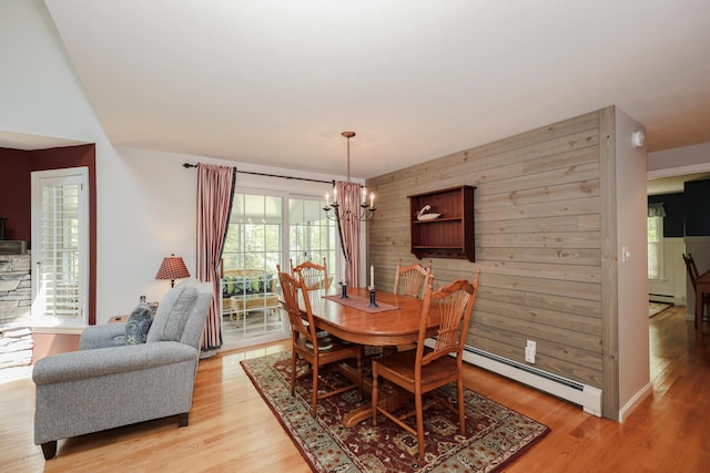 28 Winchester Ct Unit 36, Kennebunk, ME 04043 - dining area featuring a baseboard heating unit, a chandelier, and light wood finished floors
